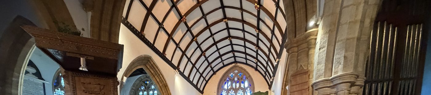 The ribbed wagon roof of the nave, looking east over the pulpit canopy to the chancel arch and the east window